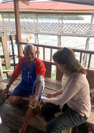 Taking blood pressure reading from one of the villagers in Kg. Karakit (November 2019)